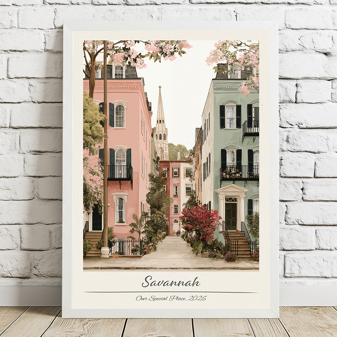 Framed artwork of a street scene in Savannah with colorful buildings and cherry blossoms.