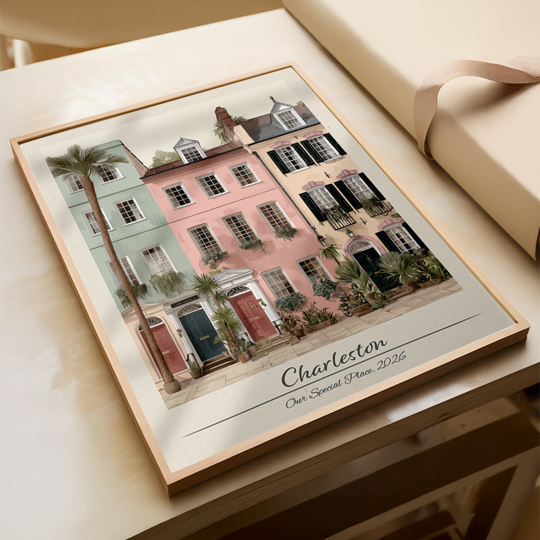 Framed artwork of a colorful building scene with 'Charleston' text on a wooden surface.