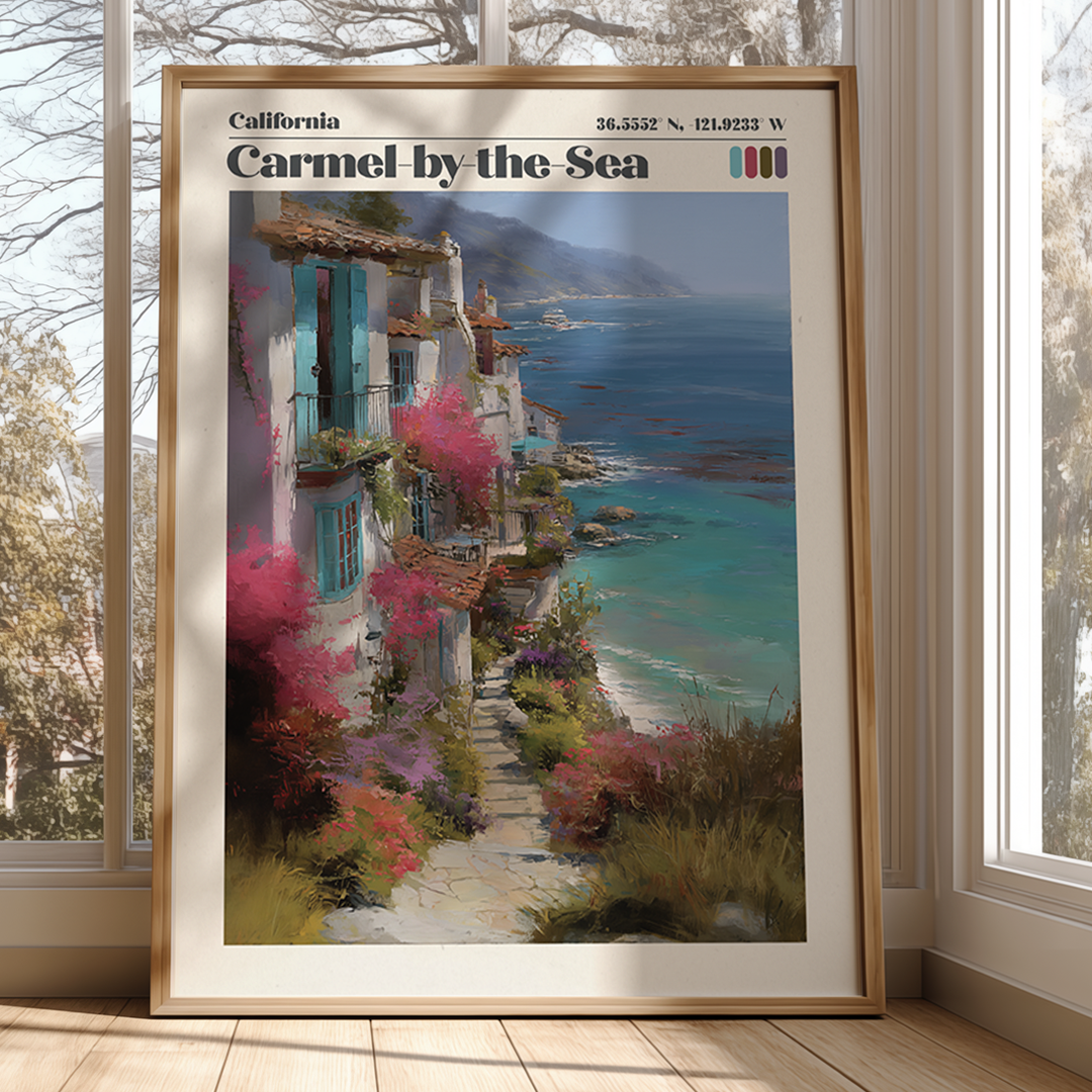 Framed artwork of a coastal scene with buildings and flowers, titled 'Carmel by the Sea'.