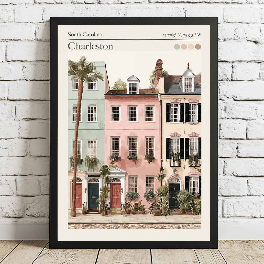 Framed artwork of Charleston buildings on a white brick wall.