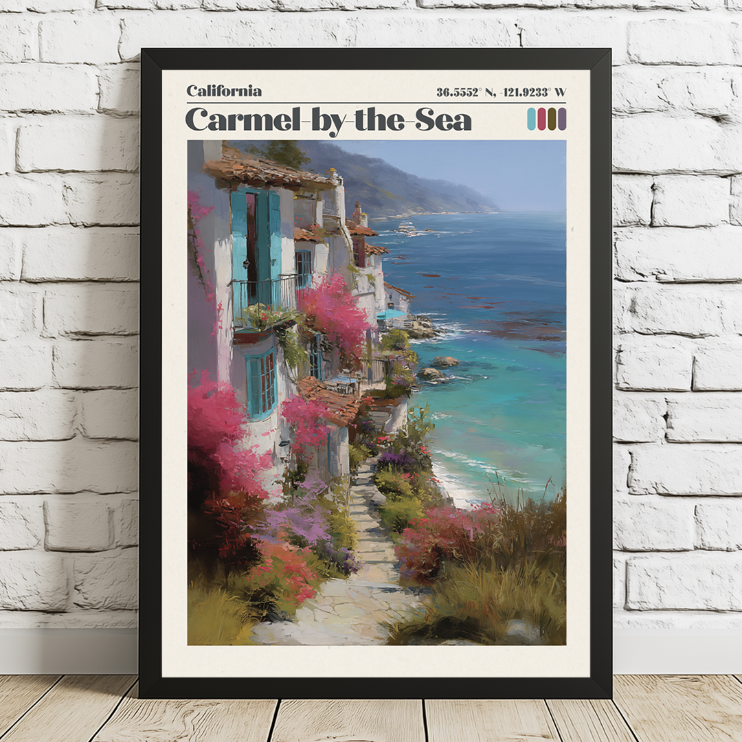 Framed artwork of a coastal scene with buildings and flowers, titled 'Carmel by the Sea', on a white brick wall.