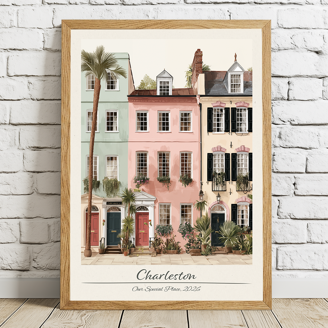Framed artwork of colorful houses with palm trees on a white brick wall.