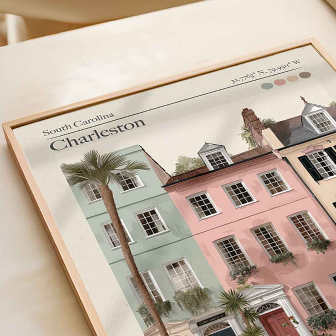 Framed artwork of Charleston, South Carolina with colorful buildings and palm trees.