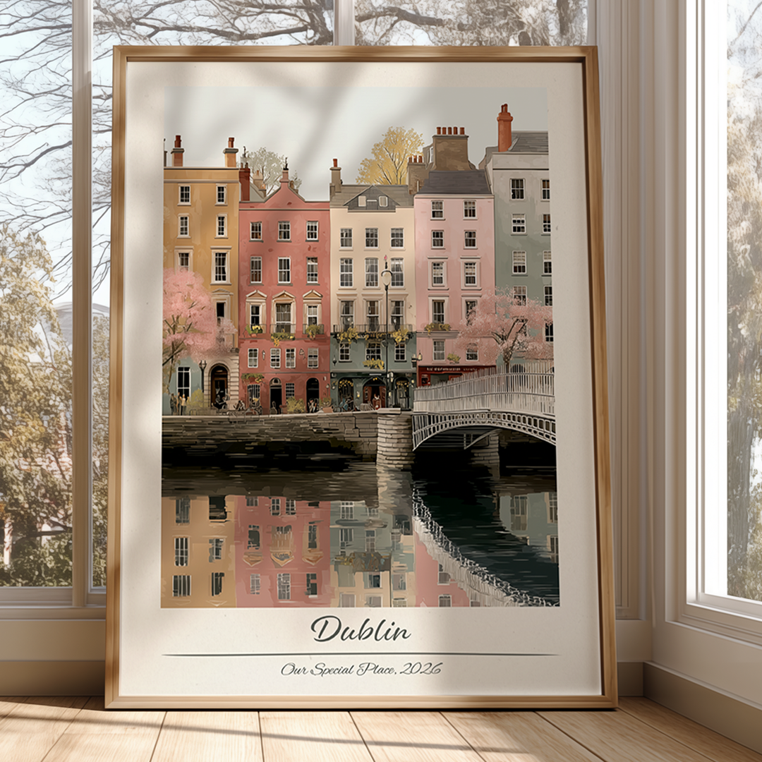 Framed artwork of a cityscape with buildings and a bridge, labeled 'Dublin', on a white brick wall.