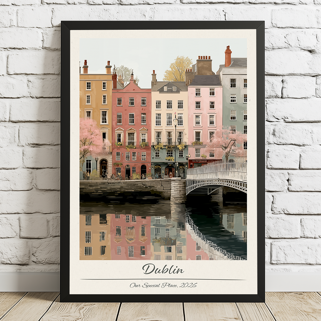 Framed artwork of a cityscape with buildings and a bridge, labeled 'Dublin', on a white brick wall.