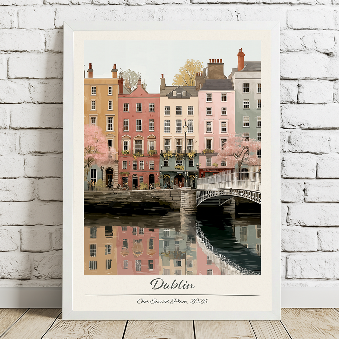 Framed artwork of a cityscape with buildings and a bridge, labeled 'Dublin', on a white brick wall.