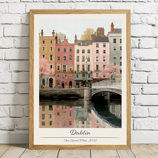 Framed artwork of a cityscape with buildings and a bridge, labeled 'Dublin', on a white brick wall.
