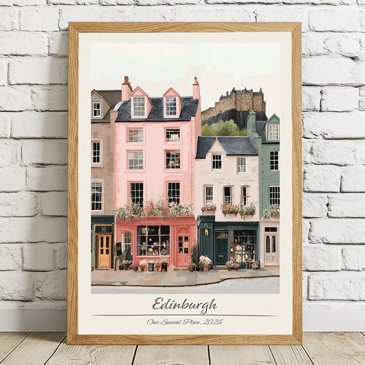 Framed artwork of Edinburgh street scene with a castle in the background on a white brick wall.