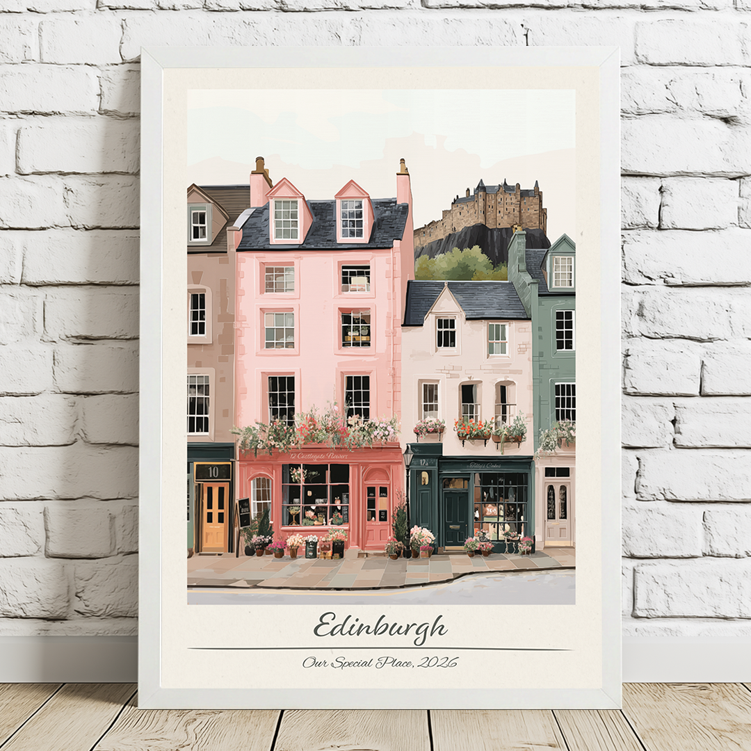 Framed artwork of a colorful street scene with 'Edinburgh' on a white brick wall background