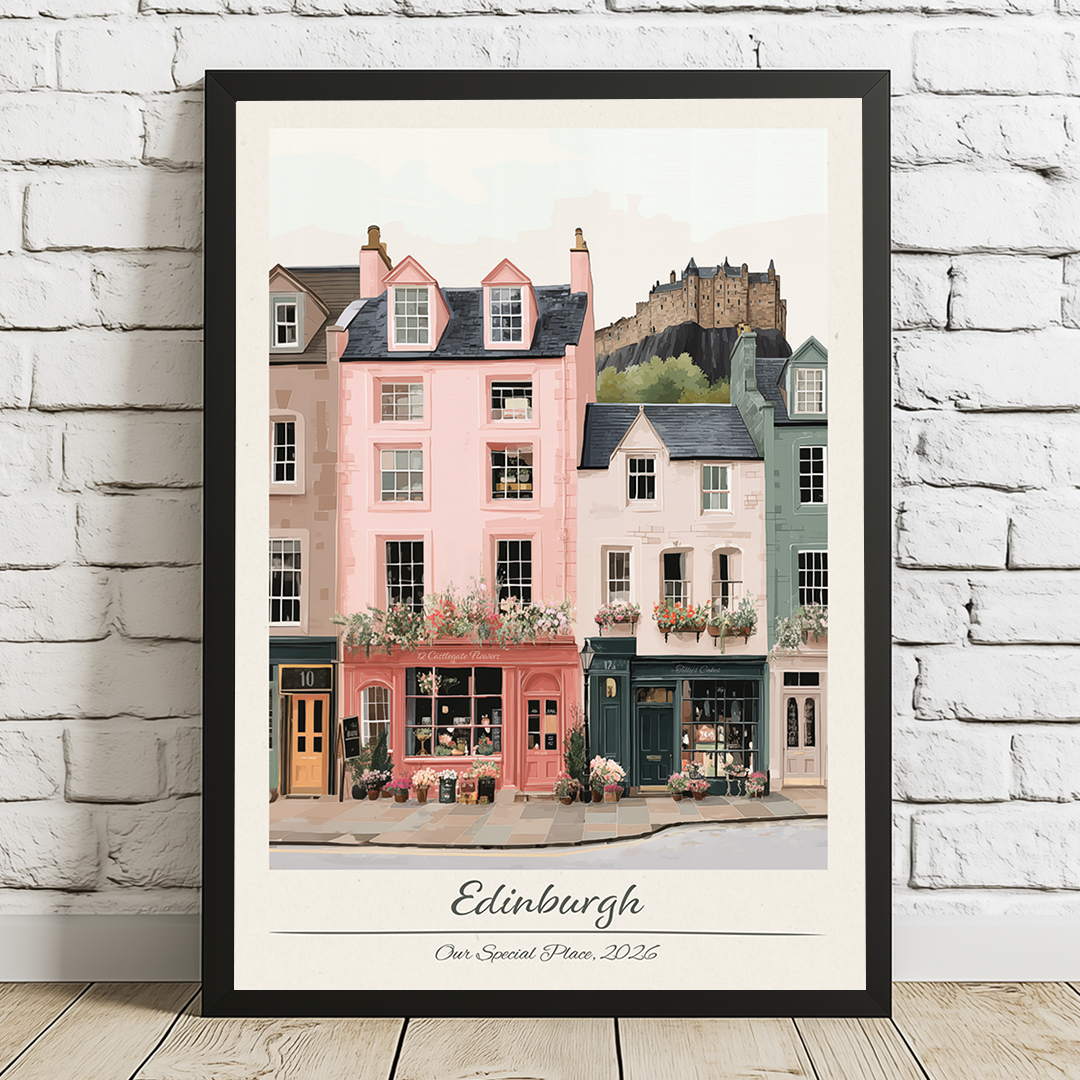 Framed artwork of Edinburgh street scene with a castle in the background on a white brick wall.