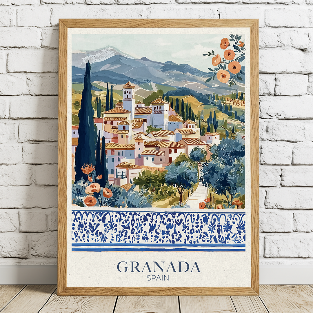 Framed artwork of Granada, Spain with scenic village and mountains on a white brick wall in an oak frame