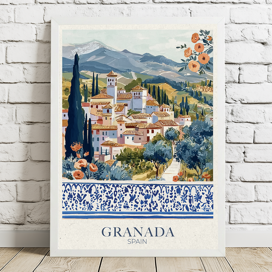 Framed artwork of Granada, Spain with scenic village and mountains on a white brick wall in a white frame