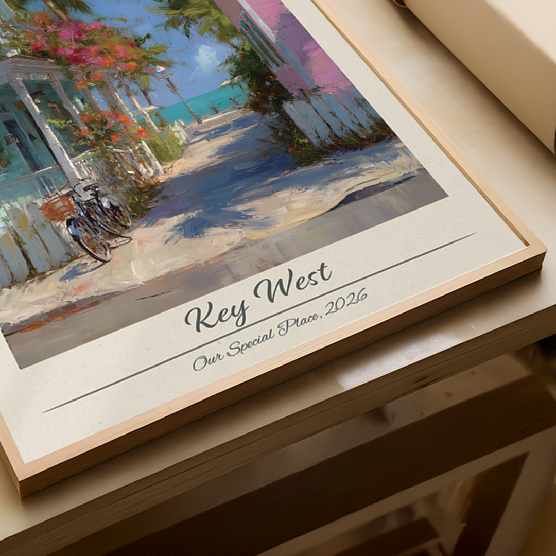 Framed artwork of a street scene with 'Key West' and '2026' text on a wooden surface.
