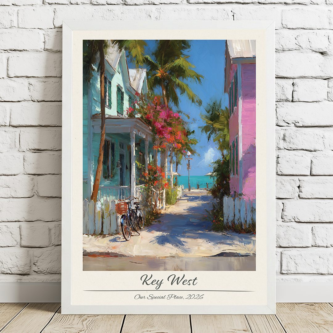 Framed artwork of a tropical street scene with houses and palm trees, titled 'Key West'.