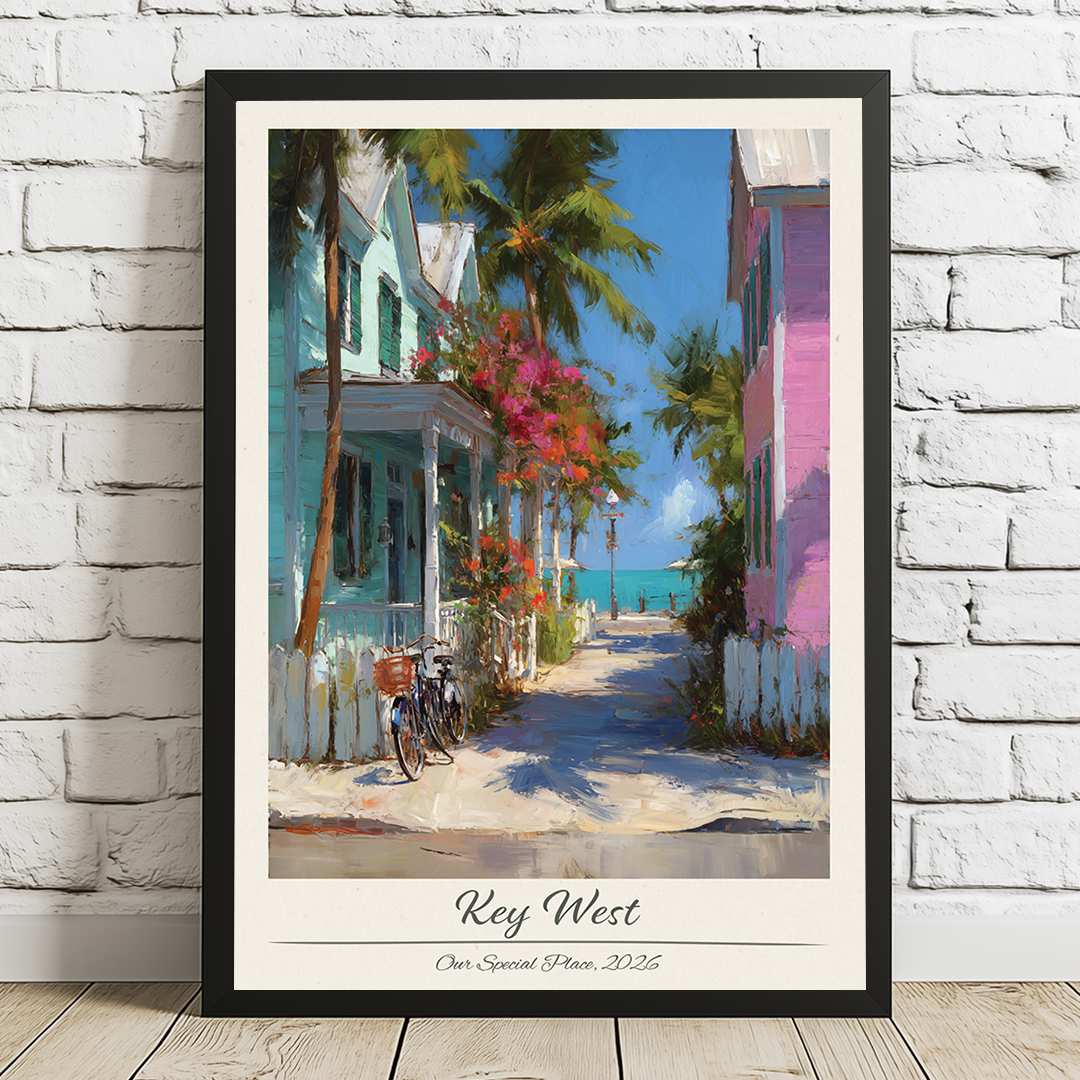 Framed artwork of a tropical street scene with houses and palm trees, titled 'Key West'.