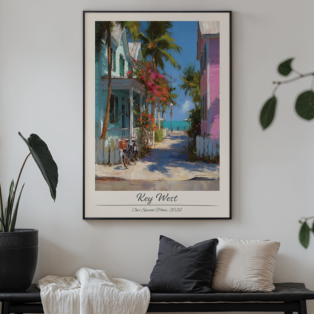 Framed artwork of a tropical street scene with houses and palm trees, titled 'Key West'.