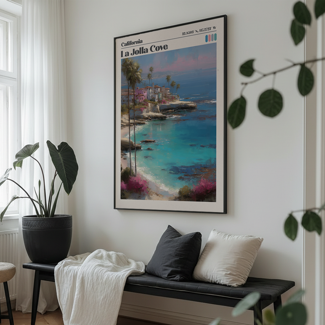 Living room with a scenic poster of La Jolla Cove on the wall, a bench with pillows, and plants.