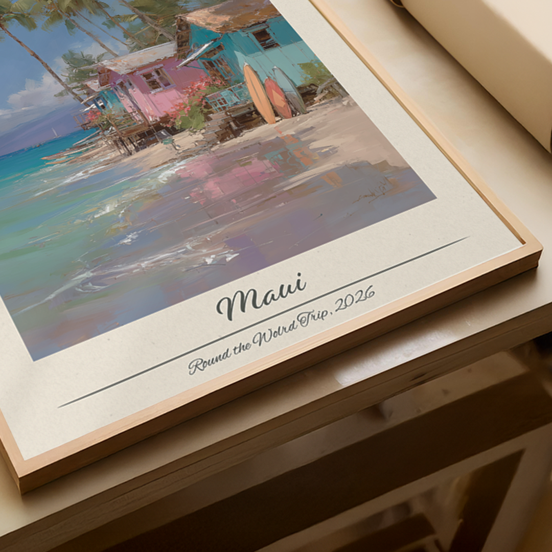 Framed artwork of a beach scene with 'Maui' and 'Round the World Trip, 2026' text.