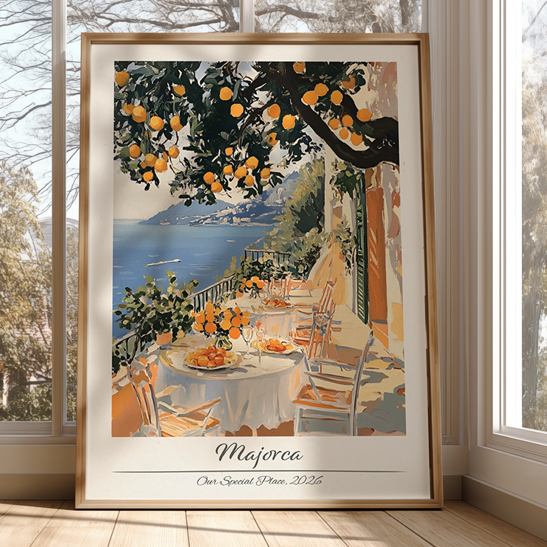 Framed artwork of a scenic outdoor setting with tables, chairs, and an orange tree.