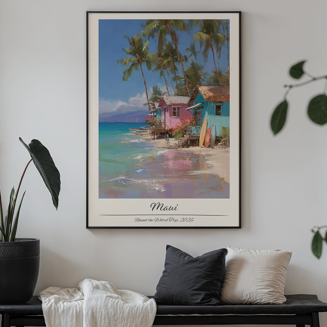 Framed artwork of a tropical beach scene with houses and palm trees, displayed on a wall above a bench.
