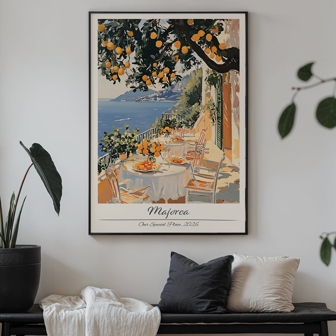 Framed artwork of a scenic outdoor dining area with an orange tree, displayed on a wall above a bench.