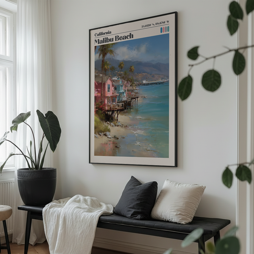 Framed artwork of Malibu Beach on a wall above a bench with cushions.