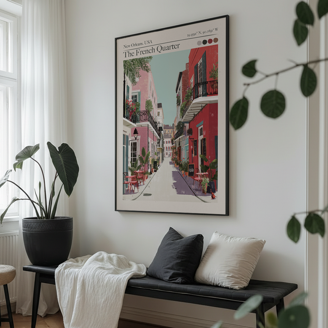 Framed artwork of a street scene in The French Quarter, New Orleans, hanging on a wall above a bench with cushions.