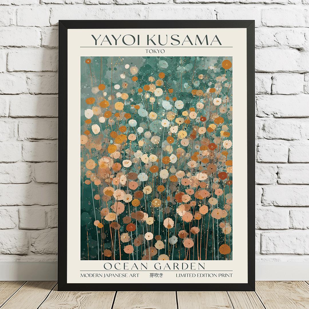 A framed art print titled 'OCEAN GARDEN' by Yayoi Kusama, featuring an abstract floral pattern in teal, orange, and cream, displayed against a white brick wall and light wood floor.