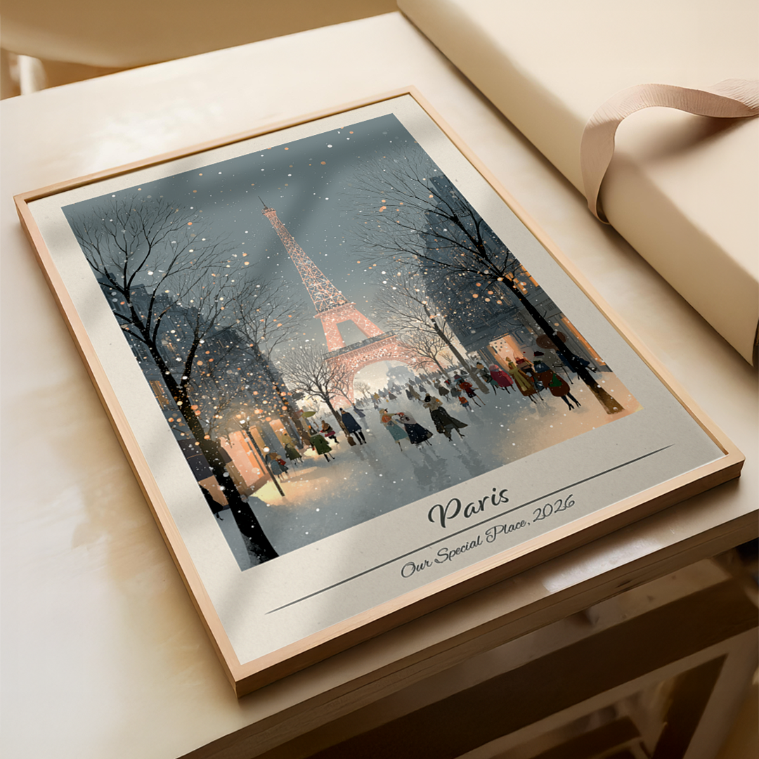 Framed artwork of the Eiffel Tower in Paris with people around, on a wooden surface.