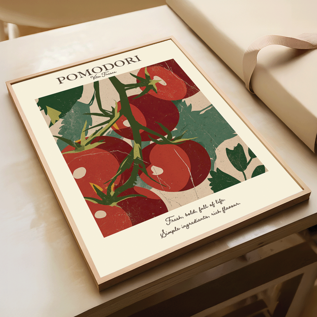 A framed art print titled 'POMODORI' featuring a stylized illustration of red tomatoes on the vine with green leaves, displayed on a tabletop next to a cream-colored gift box.