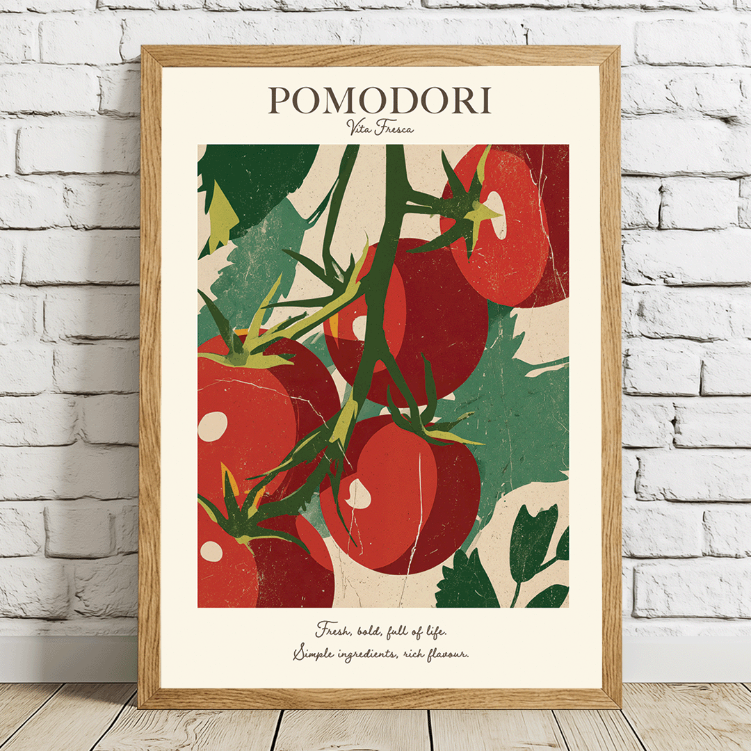 A framed vintage-style poster featuring red tomatoes on the vine with the title 'POMODORI' at the top, leaning against a white brick wall on a light wood floor.
