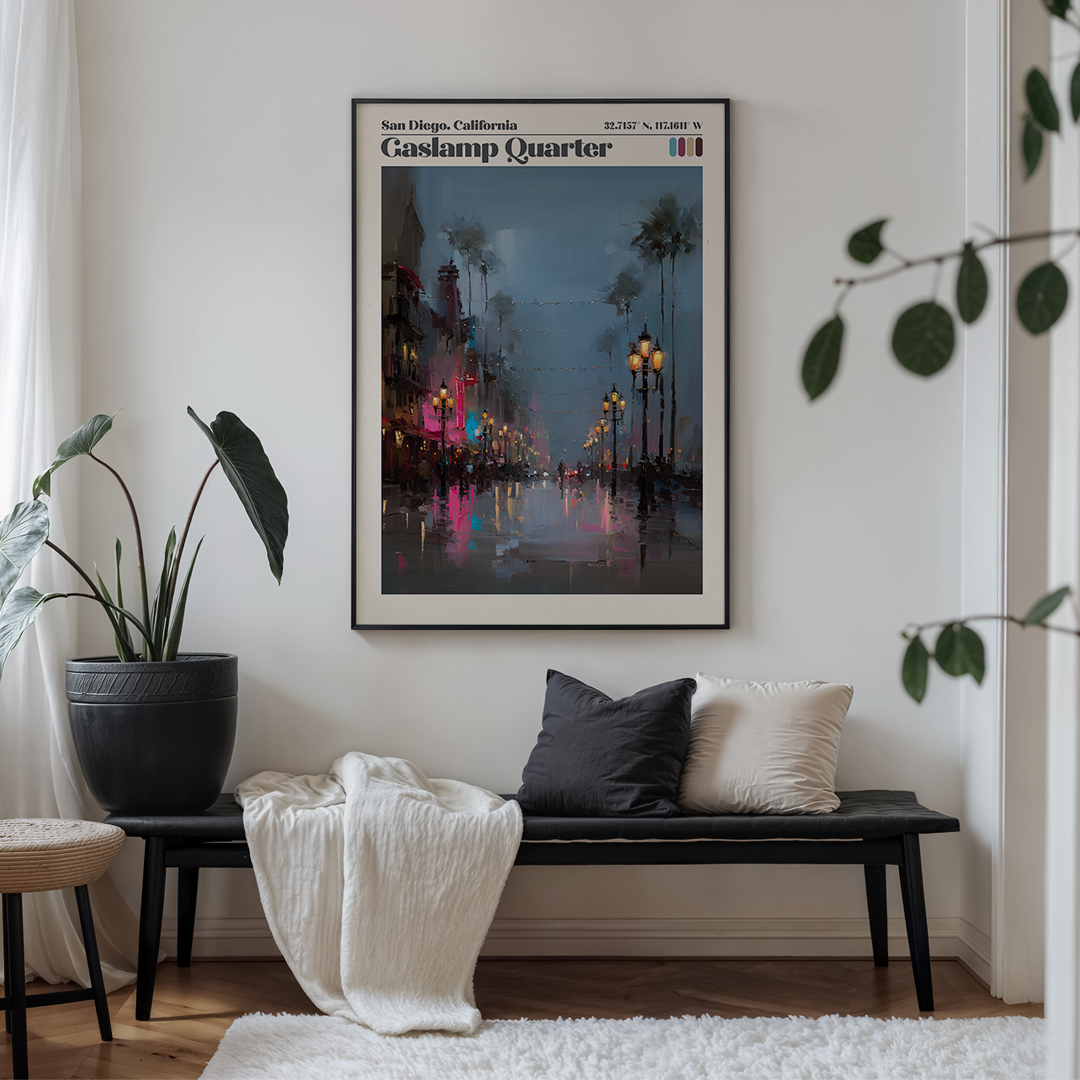 Framed artwork of Gaslamp Quarter in San Diego on a wall above a bench with cushions.