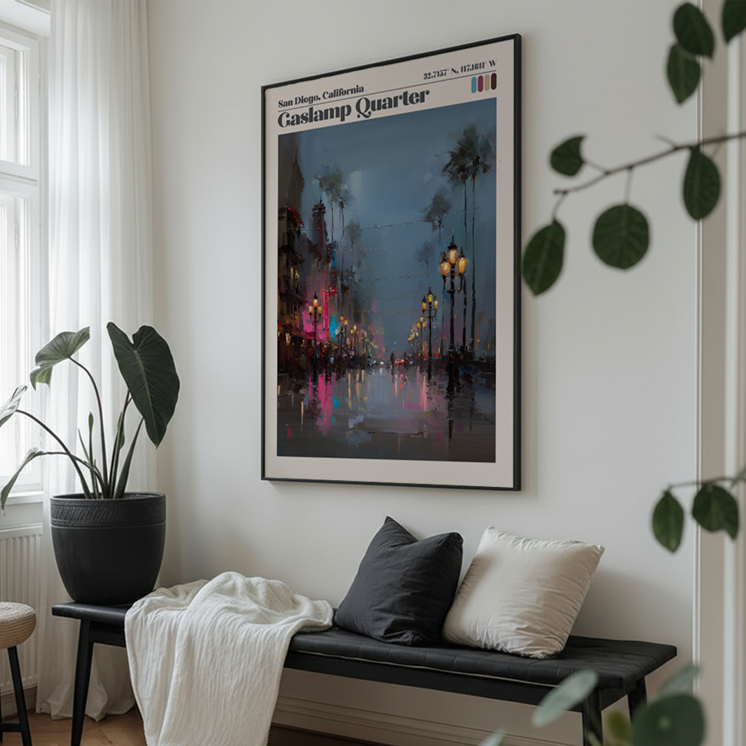 Framed artwork of Gaslamp Quarter in San Diego on a wall above a bench with cushions.