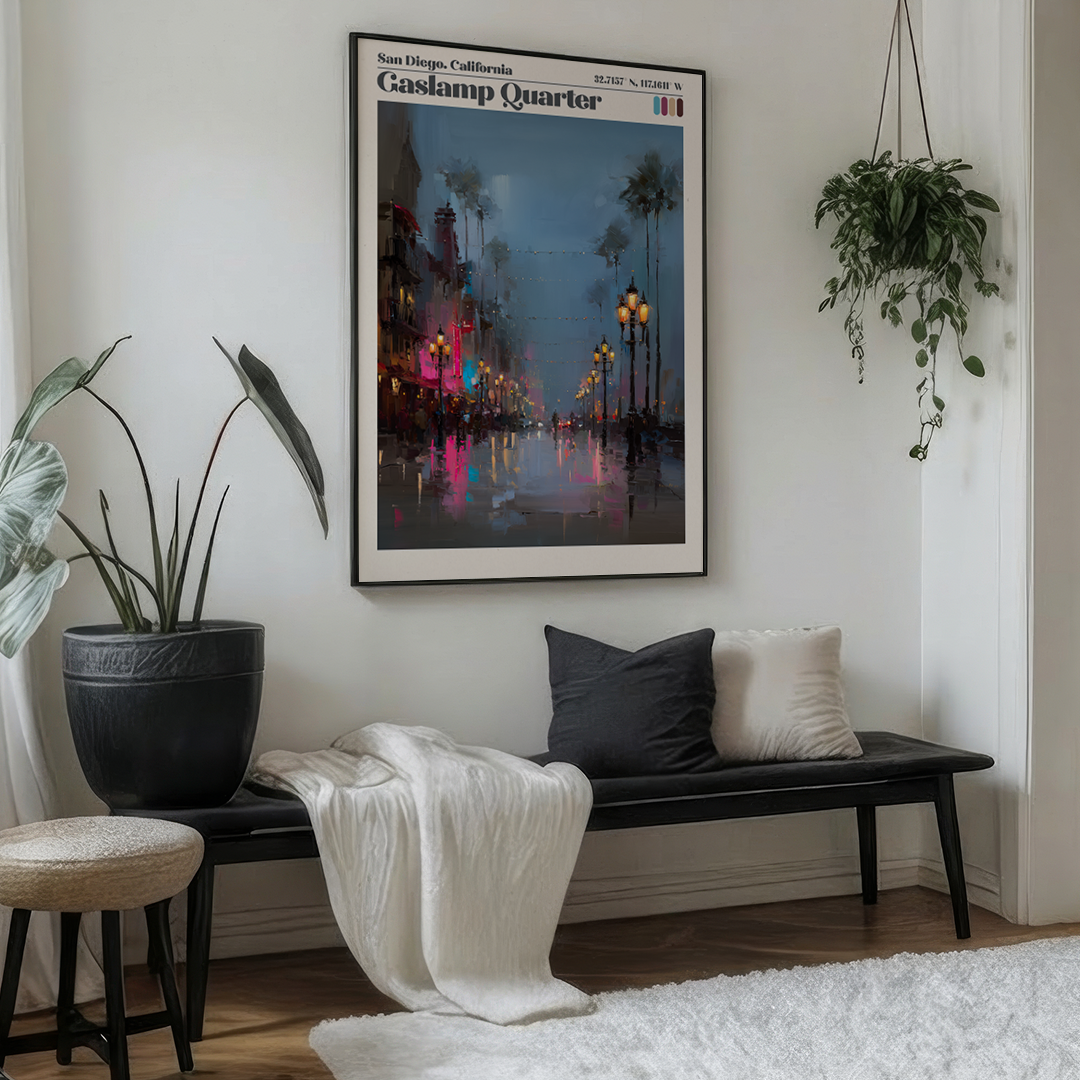 Living room with a bench, cushions, and a framed poster of Gaslamp Quarter, San Diego.