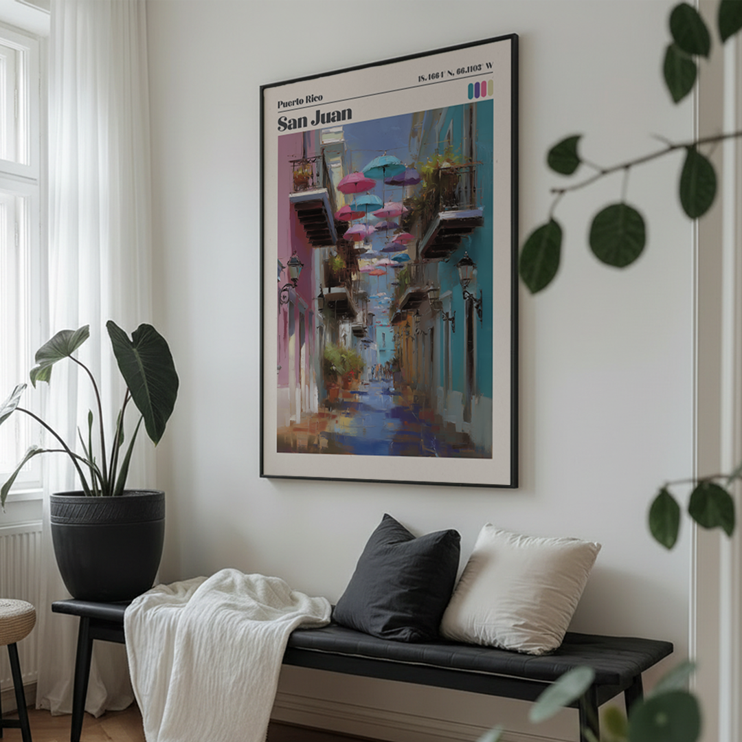 Framed artwork of a colorful street scene in a living room with a bench and plants.