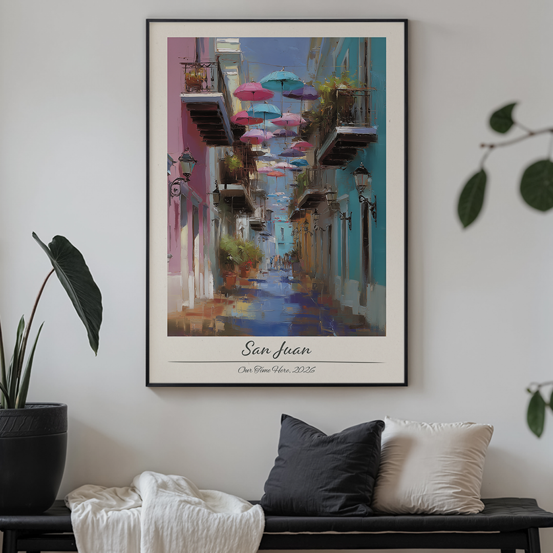 Framed artwork of a colorful street scene titled 'San Juan' in a living room setting.