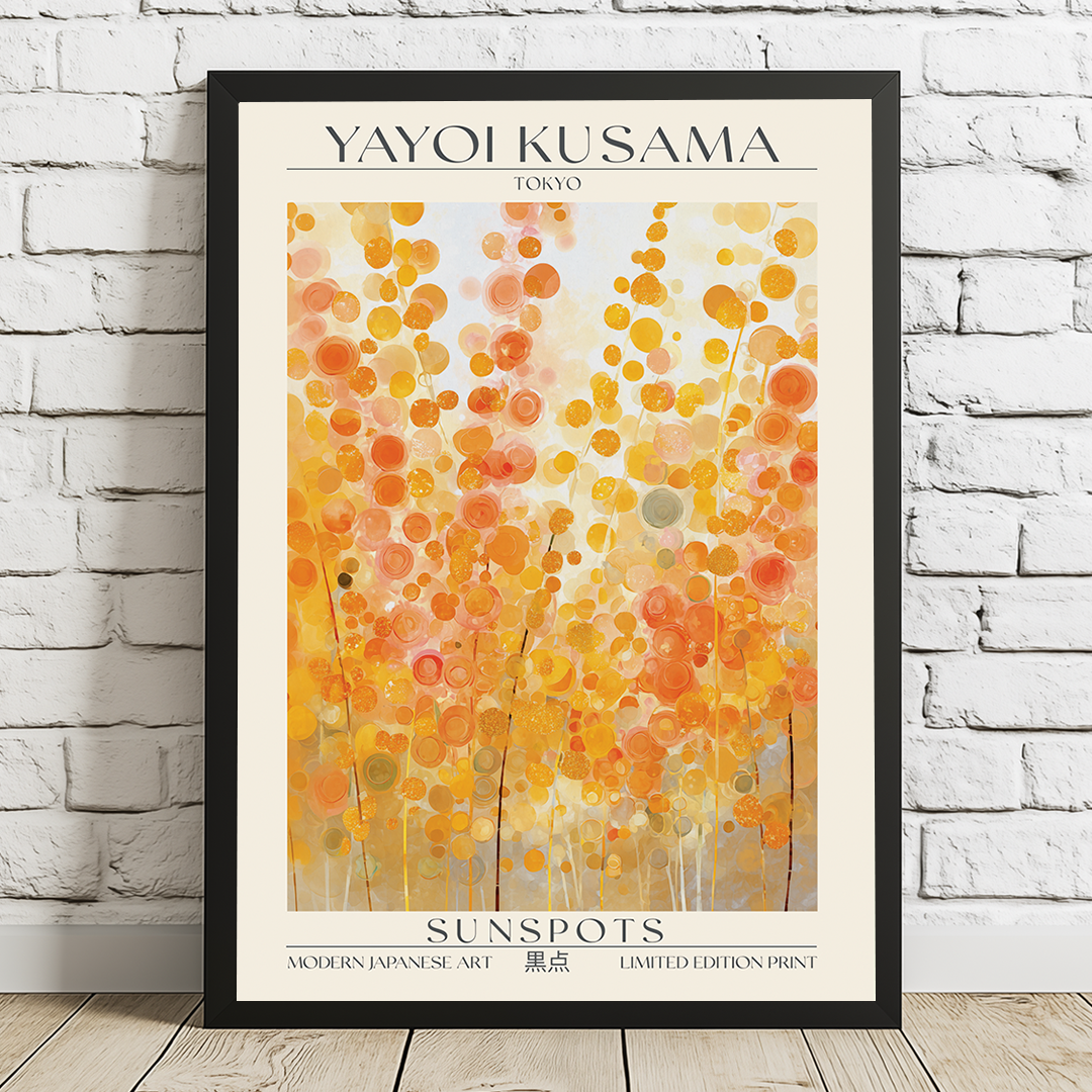 Framed Yayoi Kusama art print titled 'Sunspots' on a white brick wall.