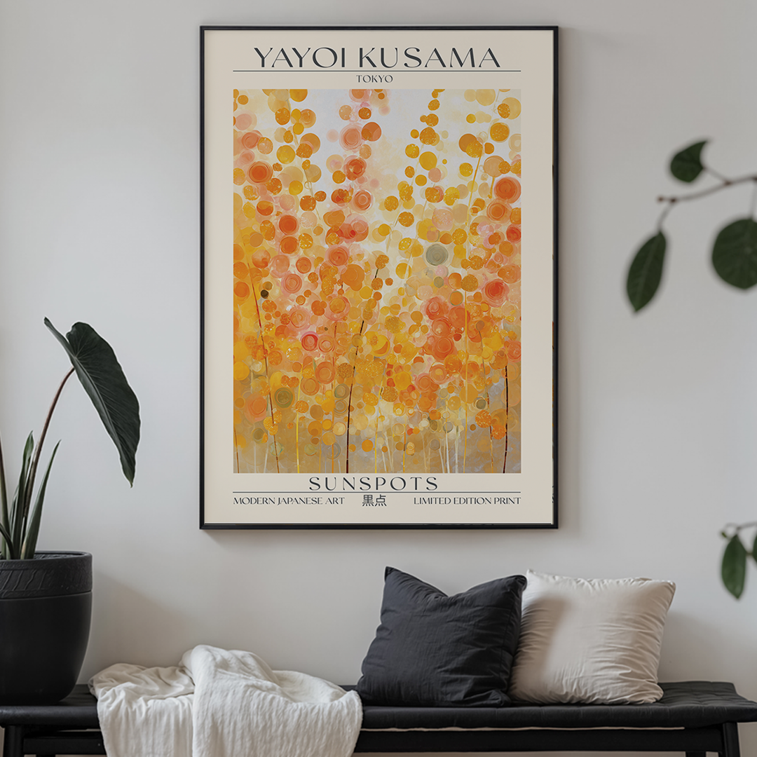 Framed Yayoi Kusama art print titled 'Sunspots' on a white brick wall