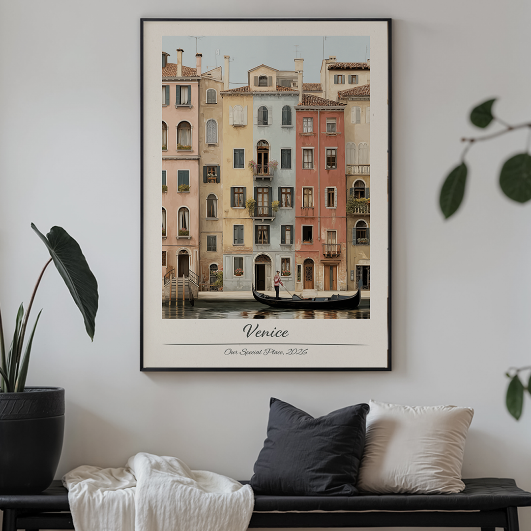 Framed artwork of a Venetian canal scene on a wall above a sofa.