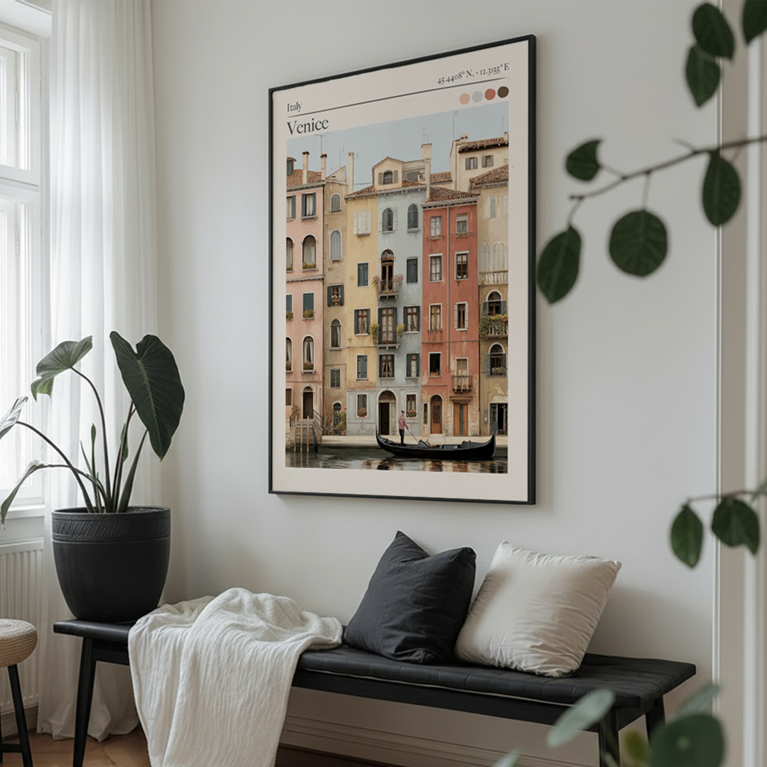 Framed artwork of Venice on a wall above a bench with cushions.