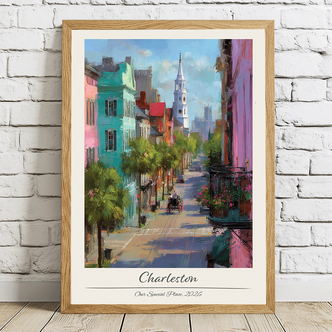 Framed artwork of a colorful street scene in Charleston on a white brick wall.
