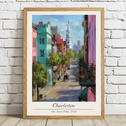 Framed artwork of a colorful street scene in Charleston on a white brick wall.