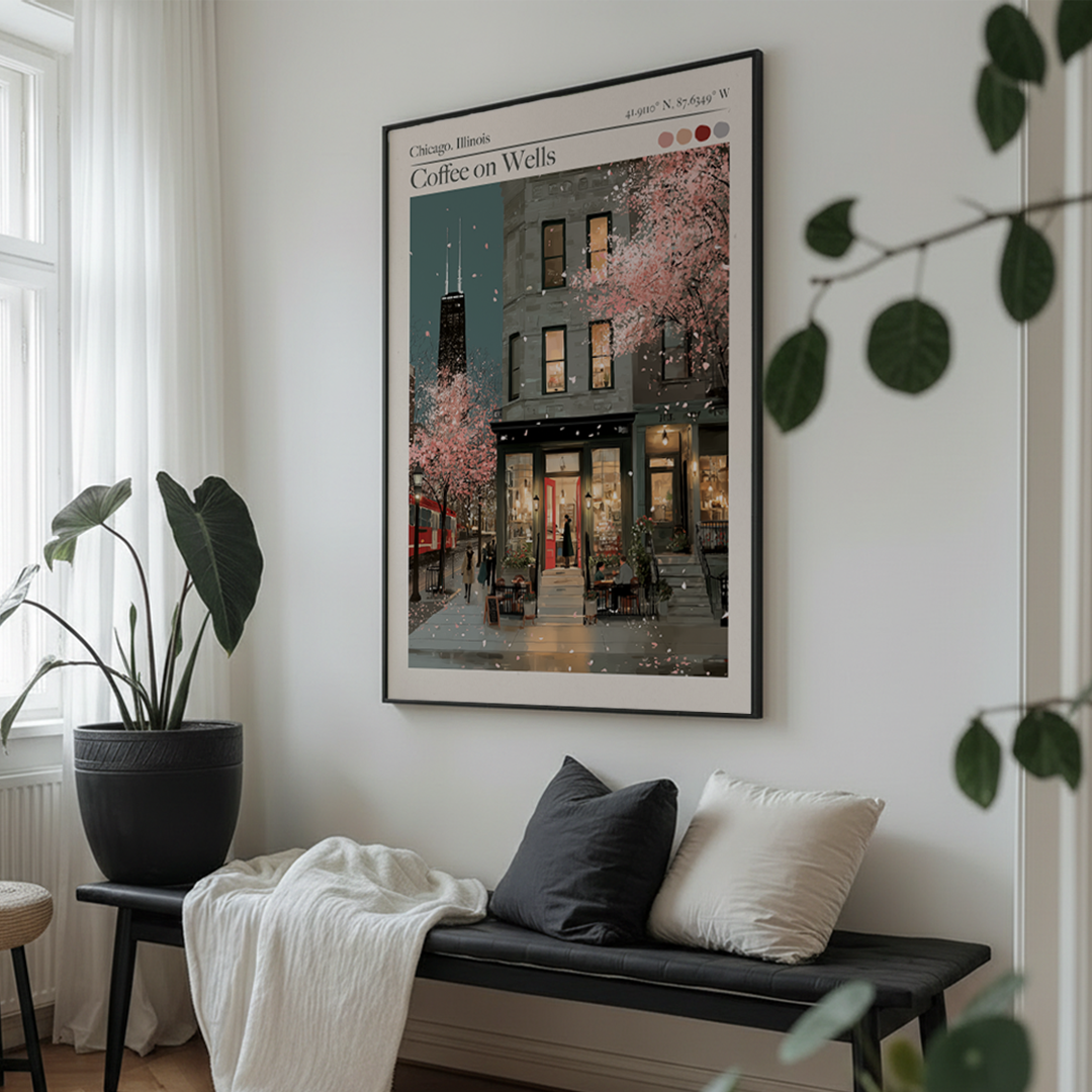 Framed artwork of a city street scene on a wall above a bench with cushions.