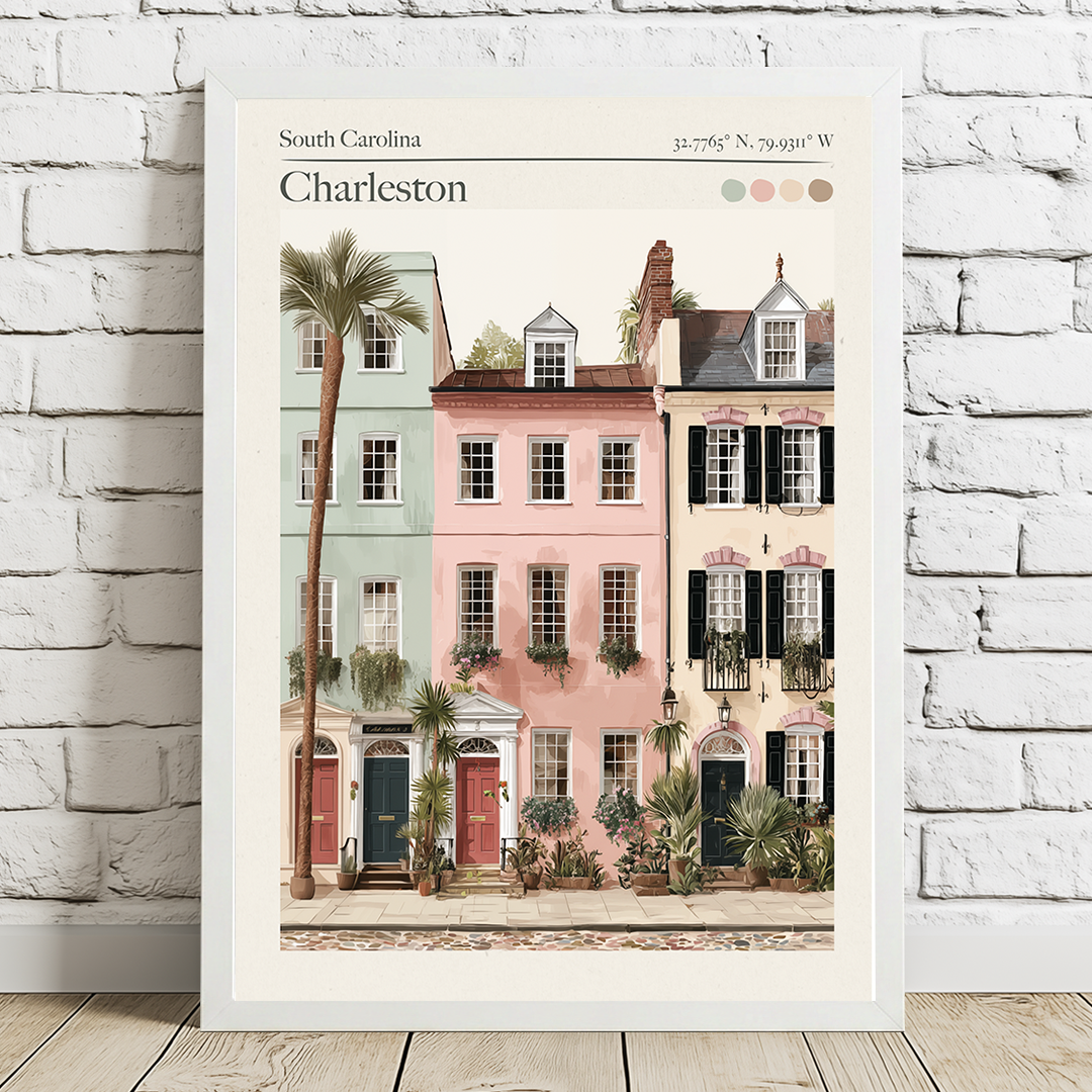Framed artwork of Charleston with colorful houses and palm trees on a white brick wall.