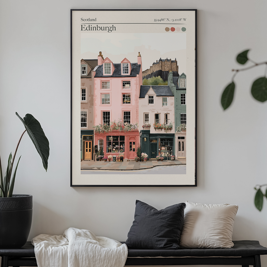 Framed artwork of Edinburgh street scene on a wall above a sofa.