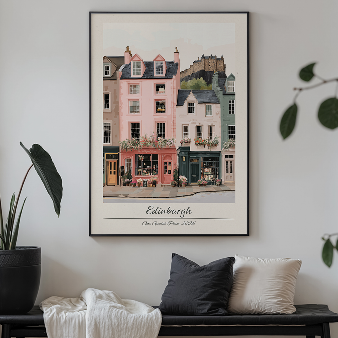 Framed artwork of Edinburgh street scene on a wall above a sofa.