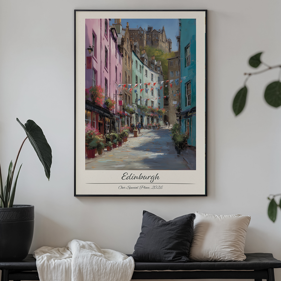 Framed artwork of a street scene in Edinburgh on a wall above a sofa.