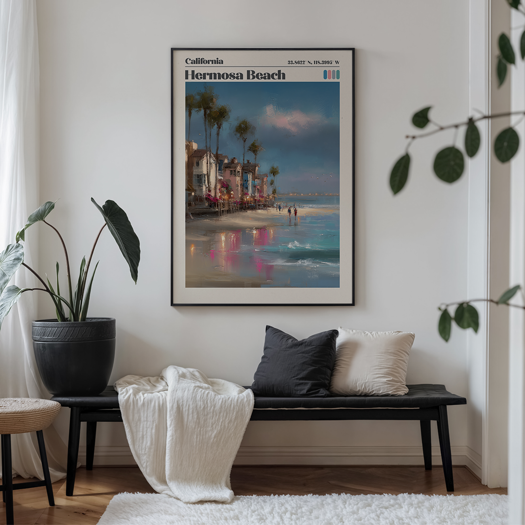 Framed poster of Hermosa Beach on a wall above a bench with cushions.