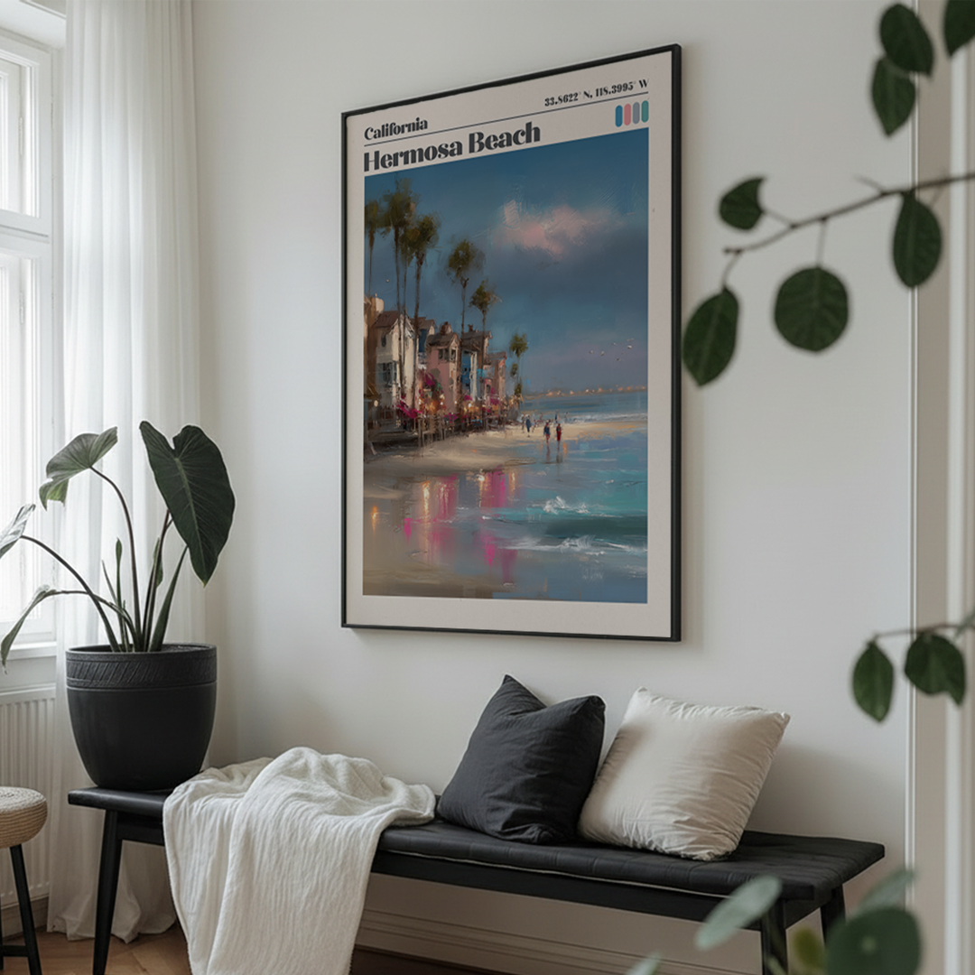 Framed poster of Hermosa Beach on a wall above a bench with cushions.