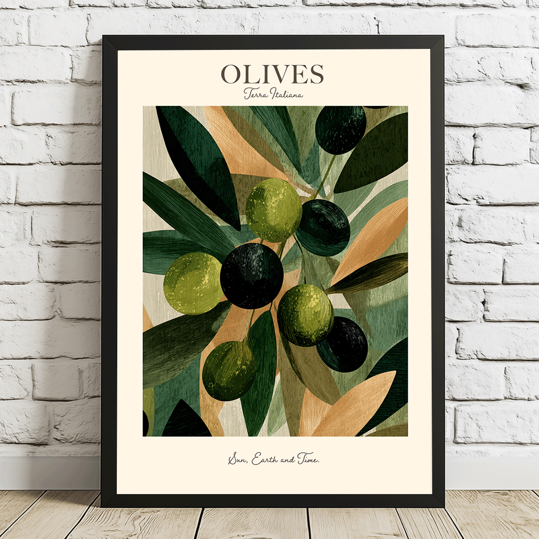 A framed art print featuring a stylized illustration of olives on a branch, leaning against a white brick wall on a light wood floor. The print has a cream background with the word 'OLIVES' at the top and 'Jen.